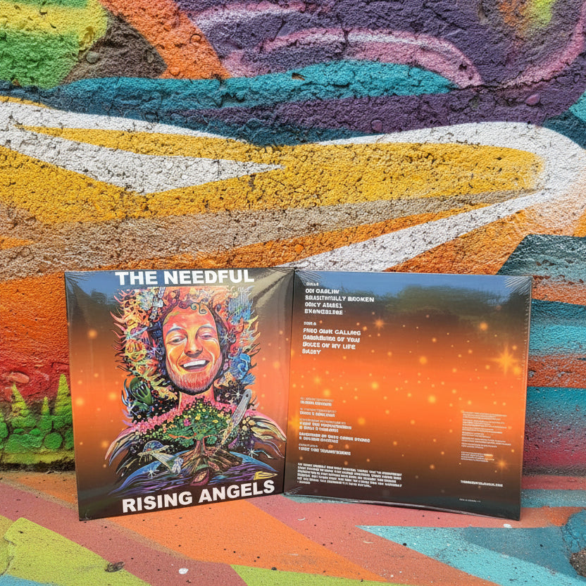 A vinyl record album shown open to display both the front cover art and the inner track listing. The front features colorful illustrated artwork with the text 'THE NEEDFUL' and 'RISING ANGELS.