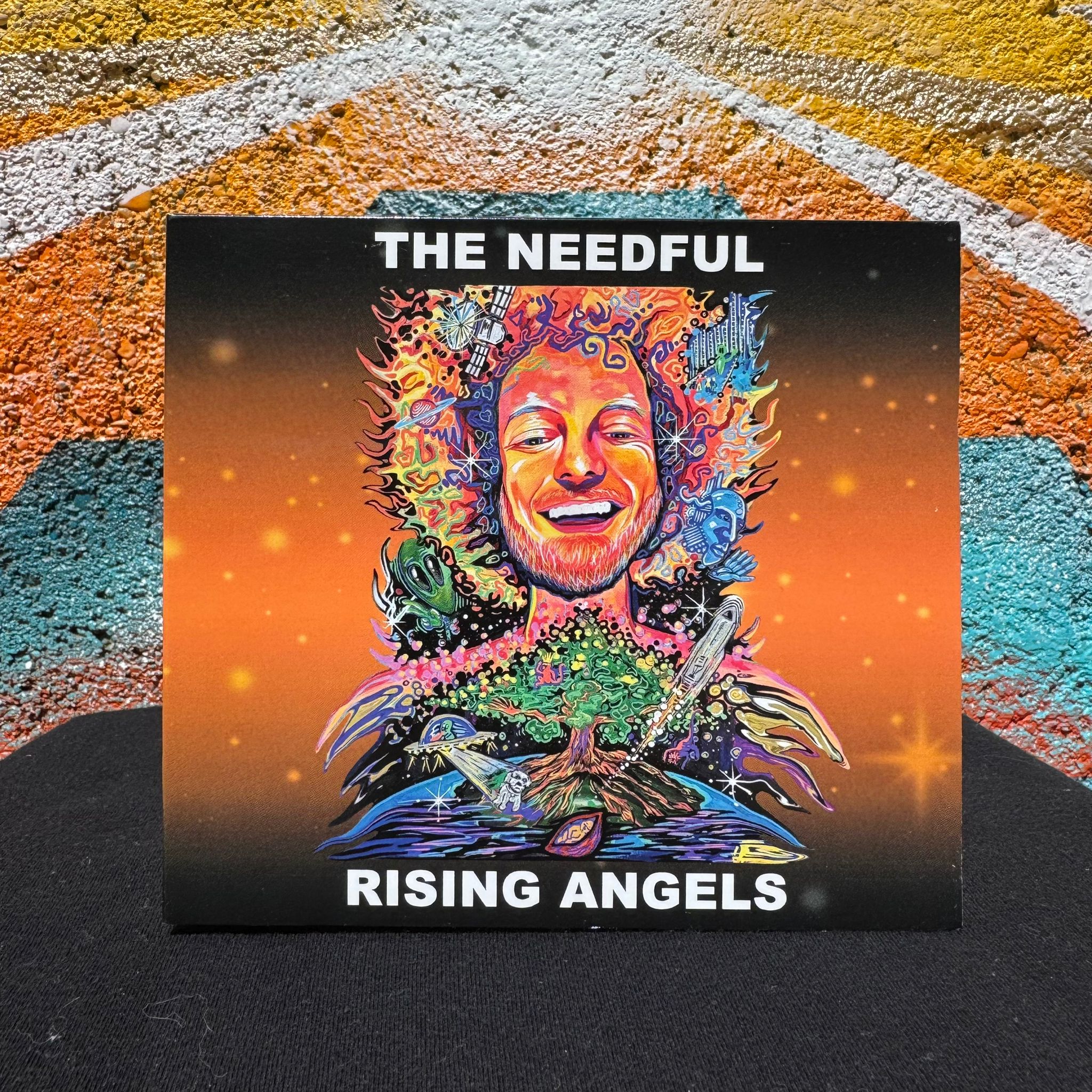 Rising Angels CD set against a colourful mural